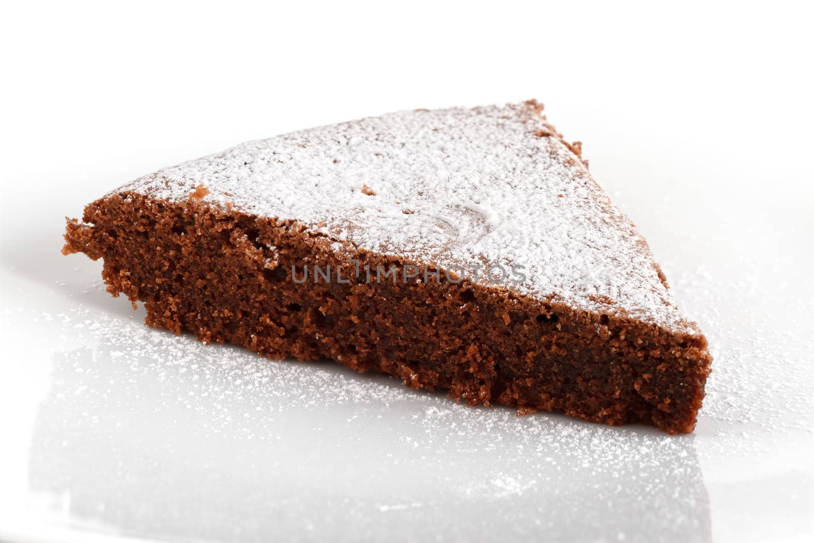 slice of chocolate cake over white background