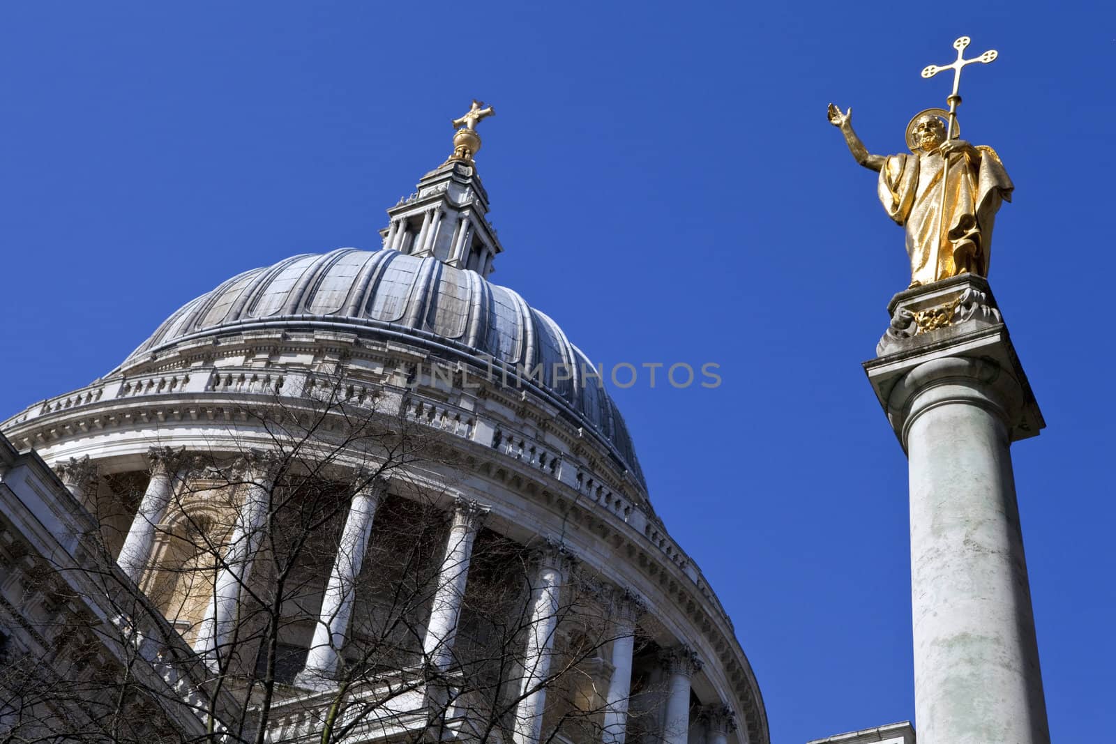 Looking up at the impressive dome of St. Paul's Cathedral and the Statue of Saint Paul in London.