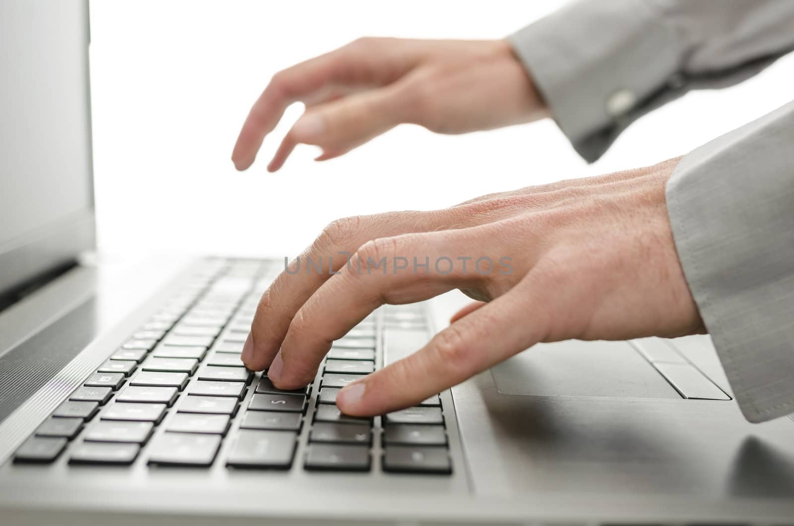 Closeup of businessman hands typing on laptop keyboard.