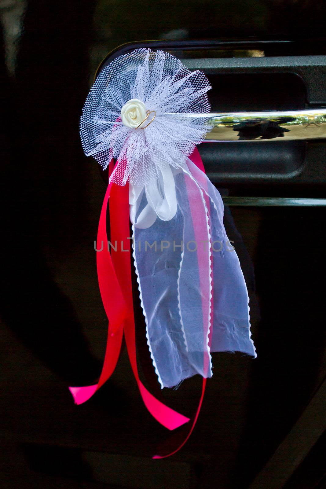 Door of wedding car with flower and ribbon by mdmmikle