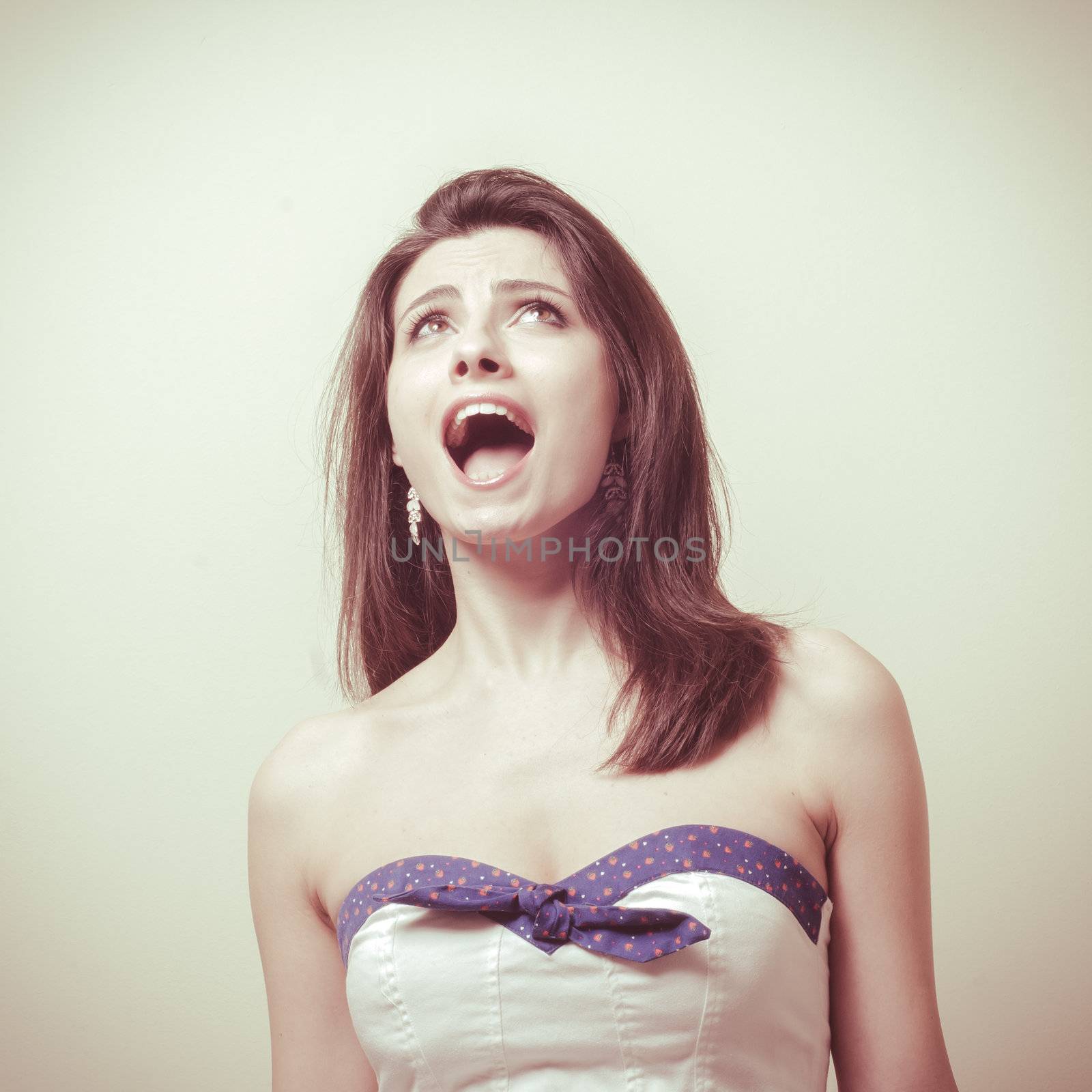 vintage portrait of young woman crying on vignetting background