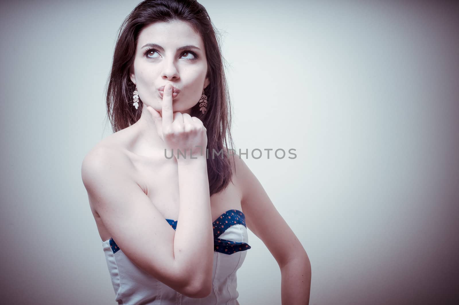 vintage portrait of young woman thinking on vignetting background