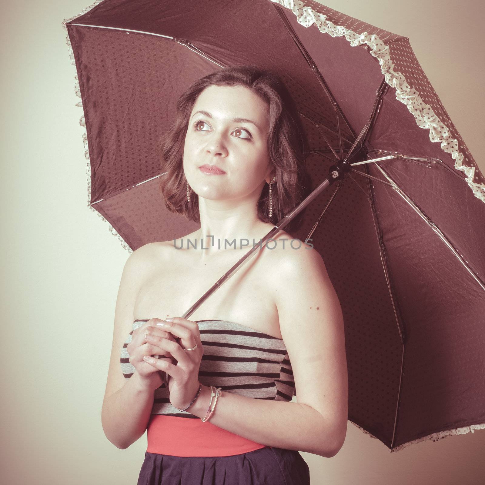 vintage portrait of young woman with umbrella on white background