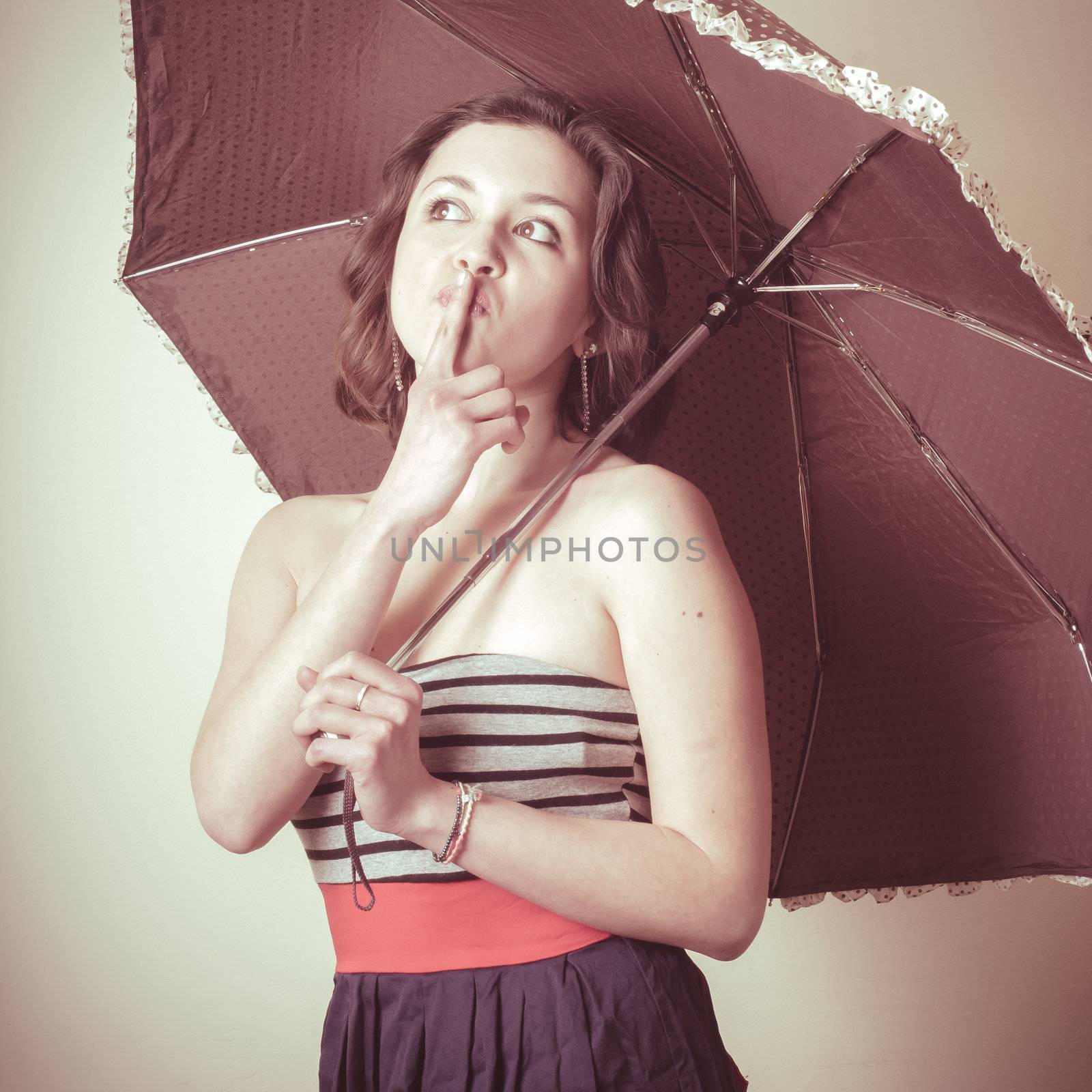 vintage portrait of young woman with umbrella on white background