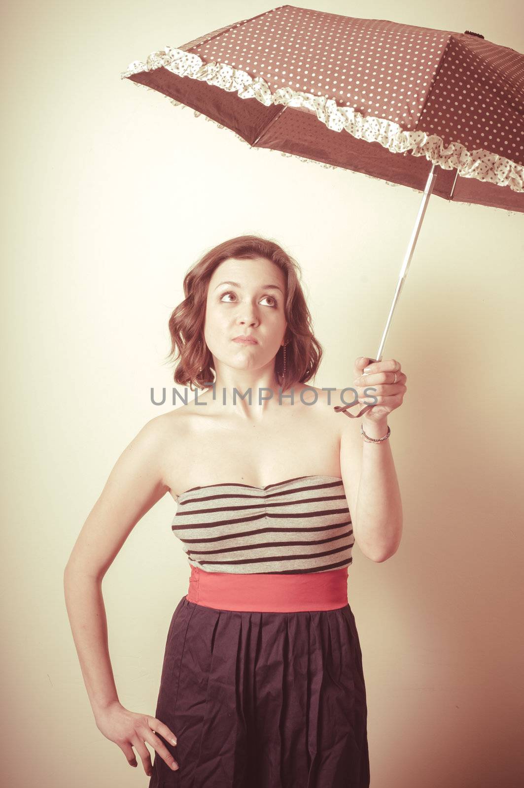 vintage portrait of young woman with umbrella on white background