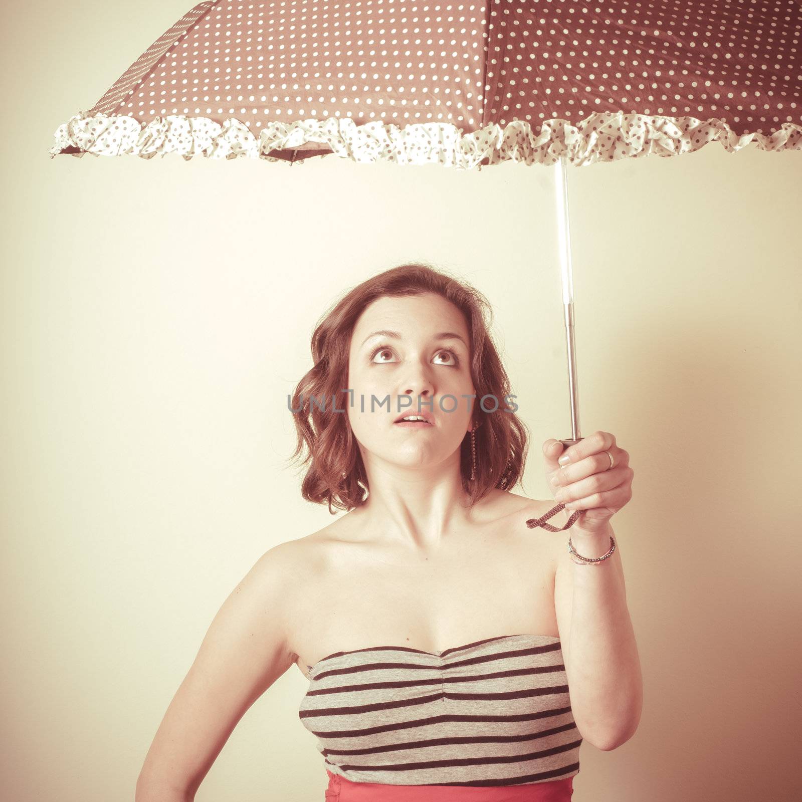 vintage portrait of young woman with umbrella on white background