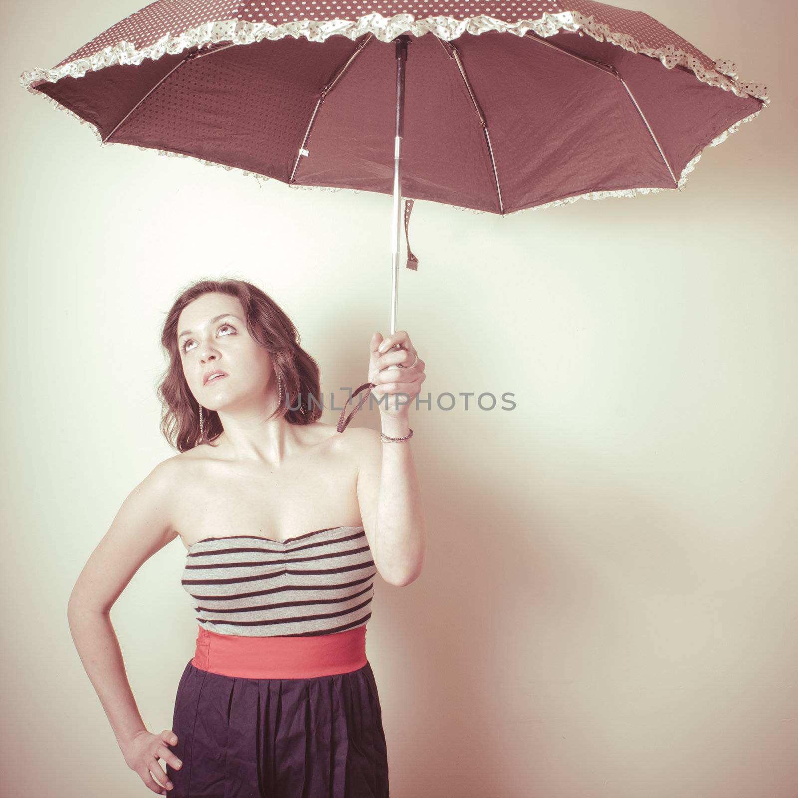 vintage portrait of young woman with umbrella on white background