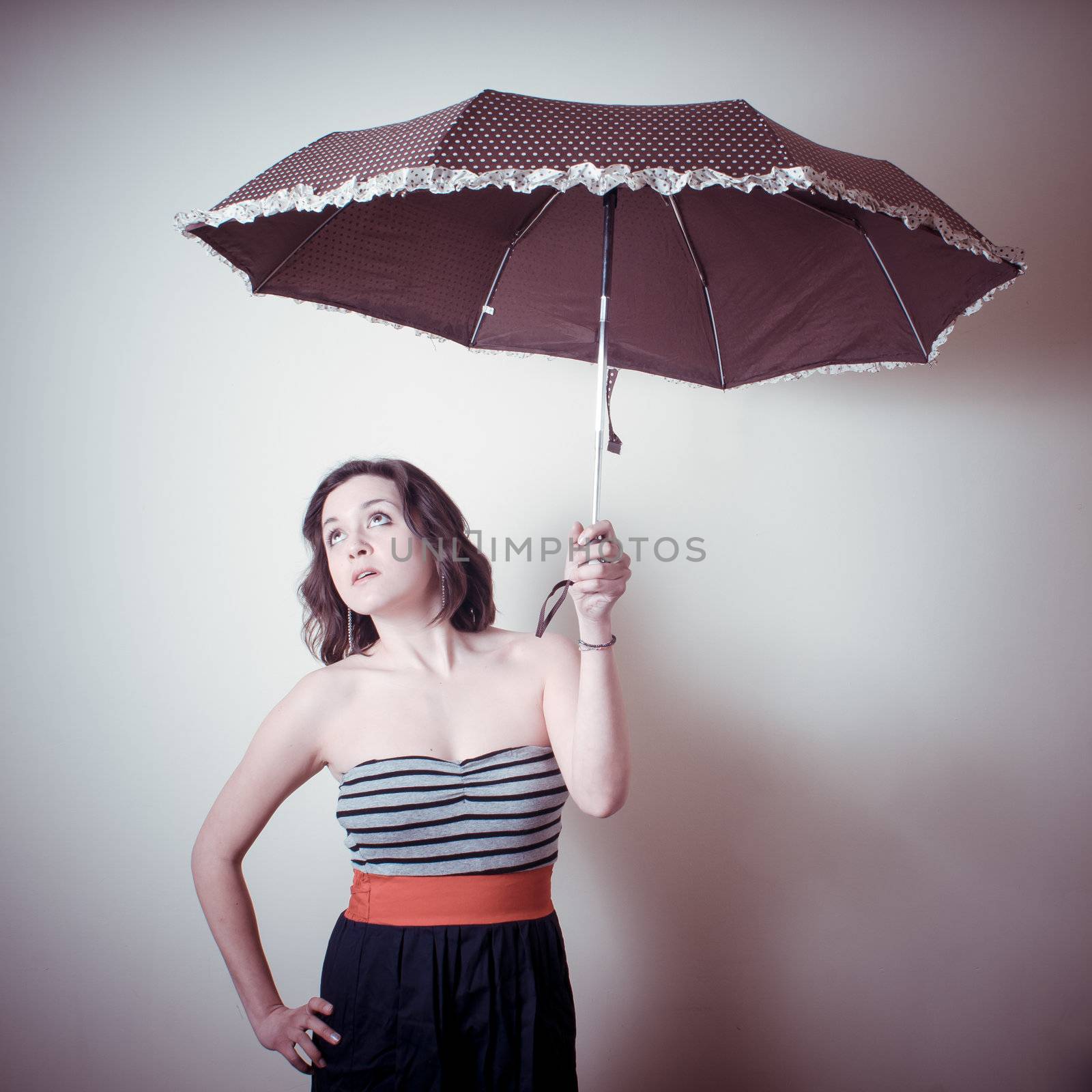 vintage portrait of young woman with umbrella on white background