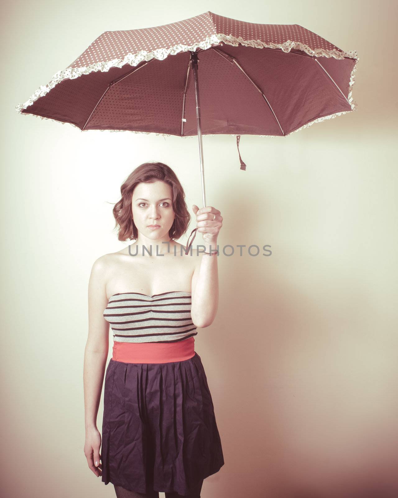 vintage portrait of young woman with umbrella on white background