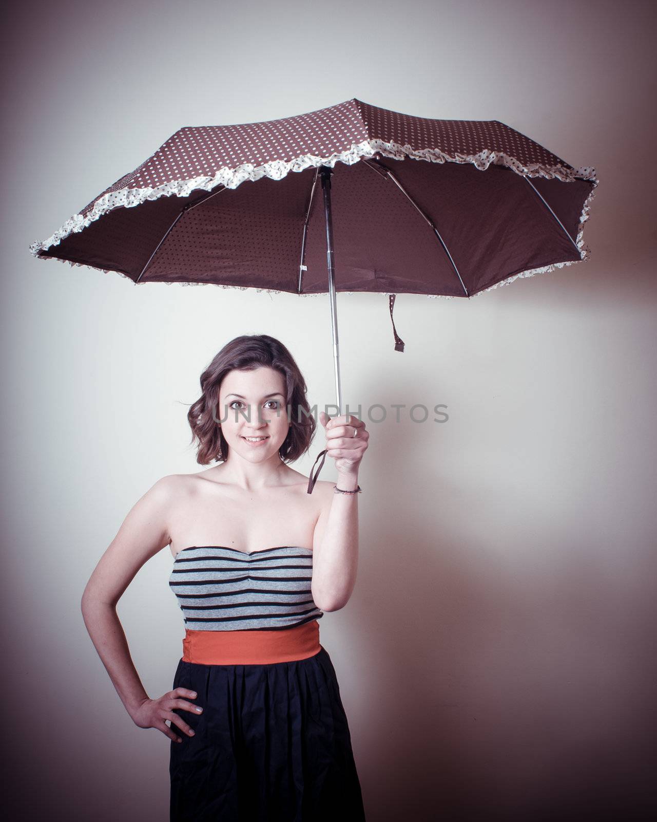 vintage portrait of young woman with umbrella on white background