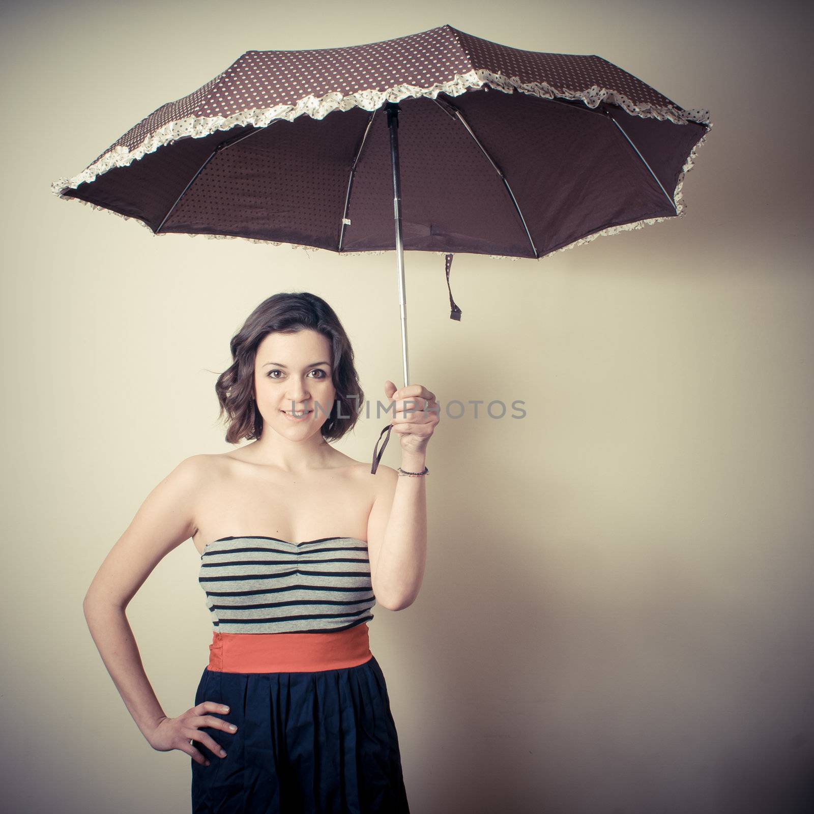 vintage portrait of young woman with umbrella on white background