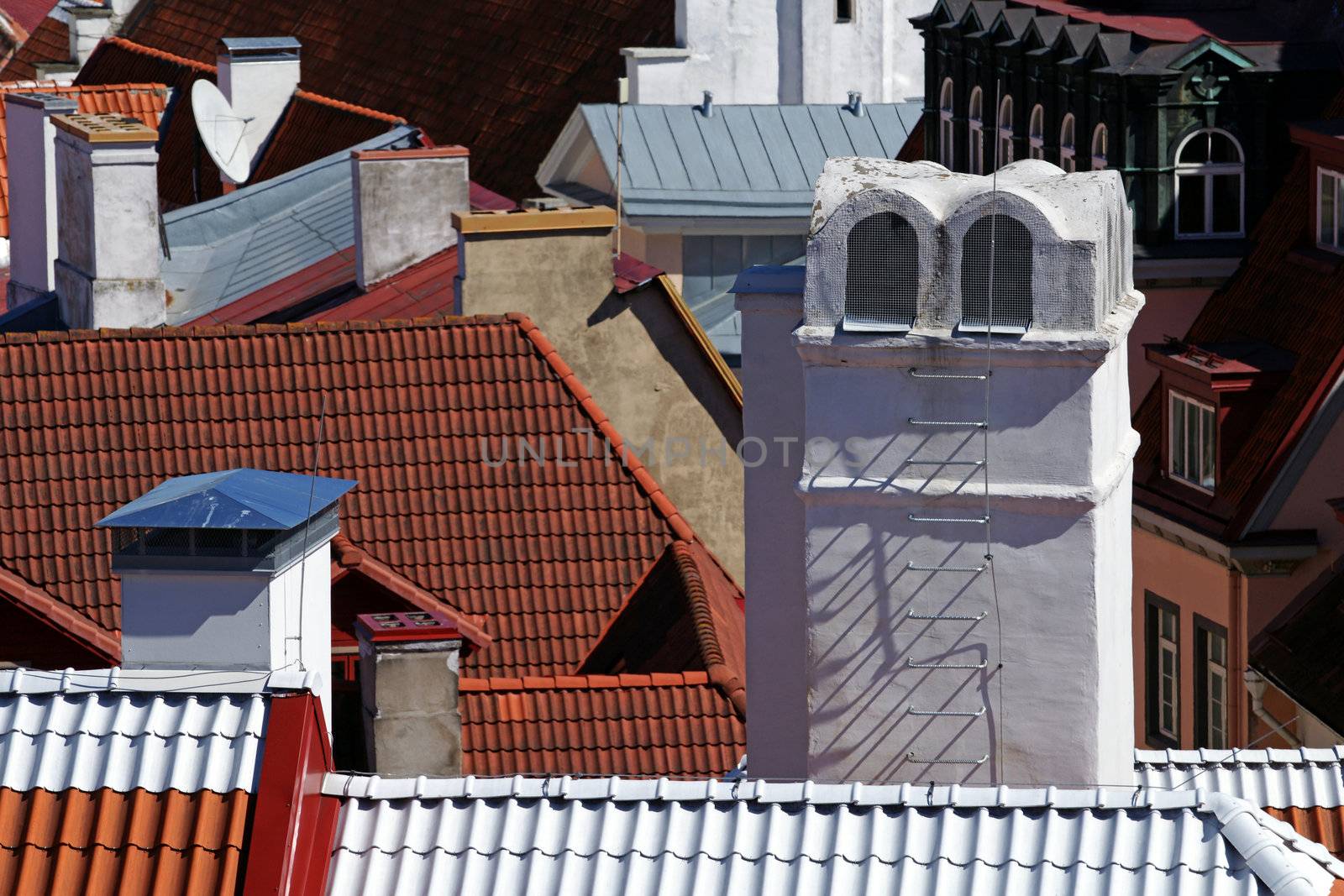 Chimney on a background of roofs of houses