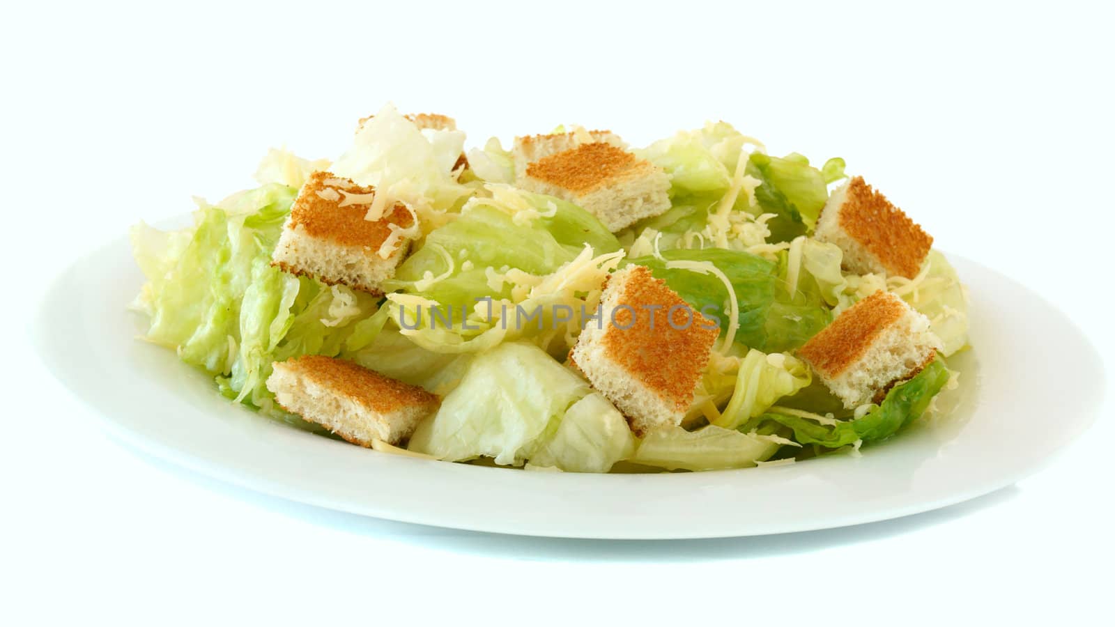 Caesar salad on white plate isolated on white background