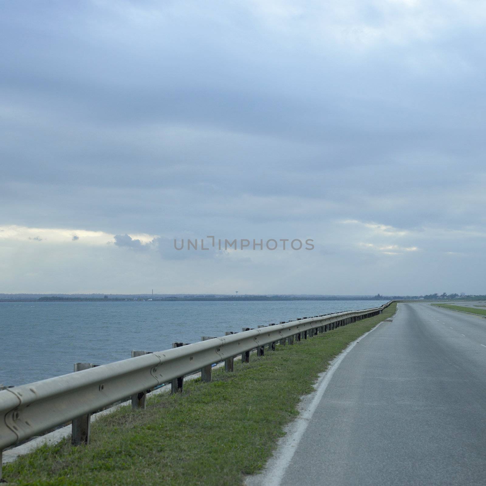 side of highway and blue ocean
