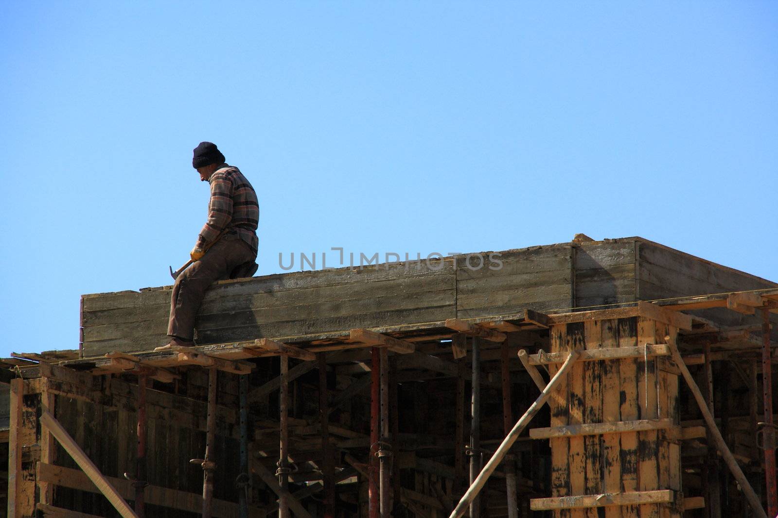 worker fixing woods for constructing building and making it ready for cement