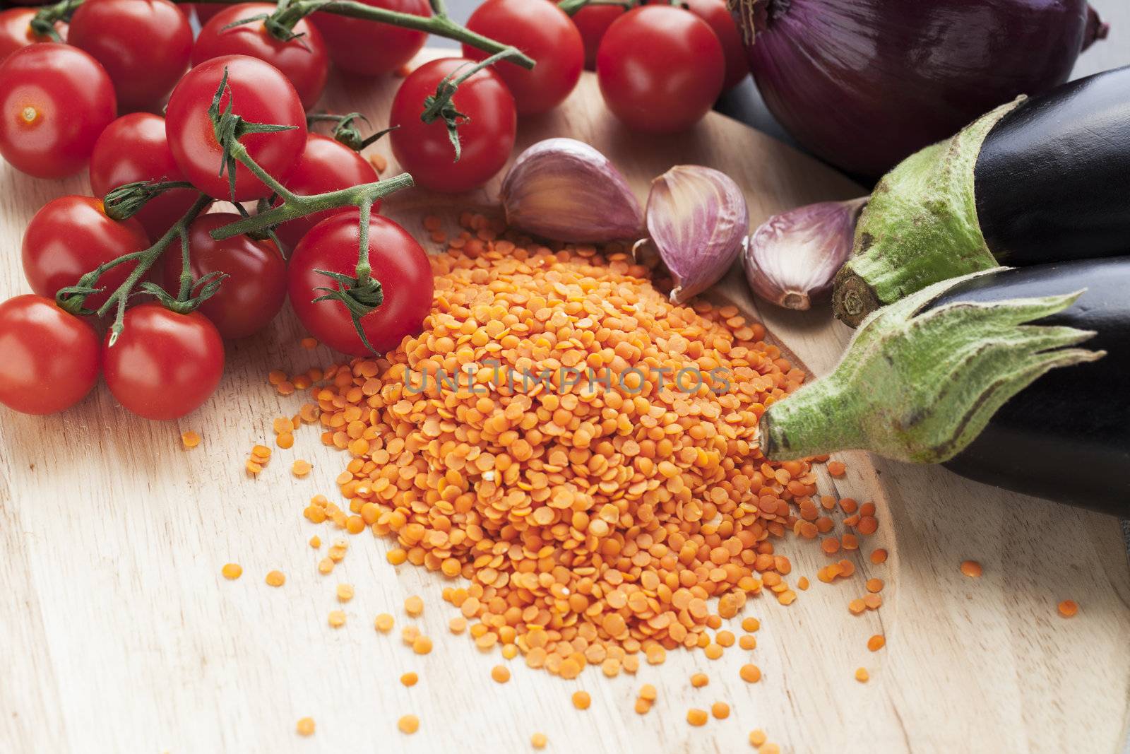 Ingredients for red lentil curry with aubergine and cherry tomatoes.