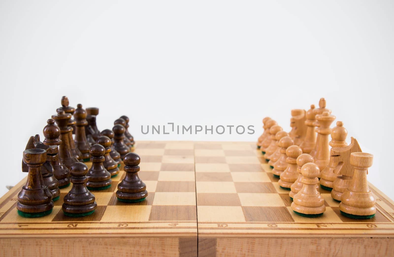 Chess on chessboard on white background