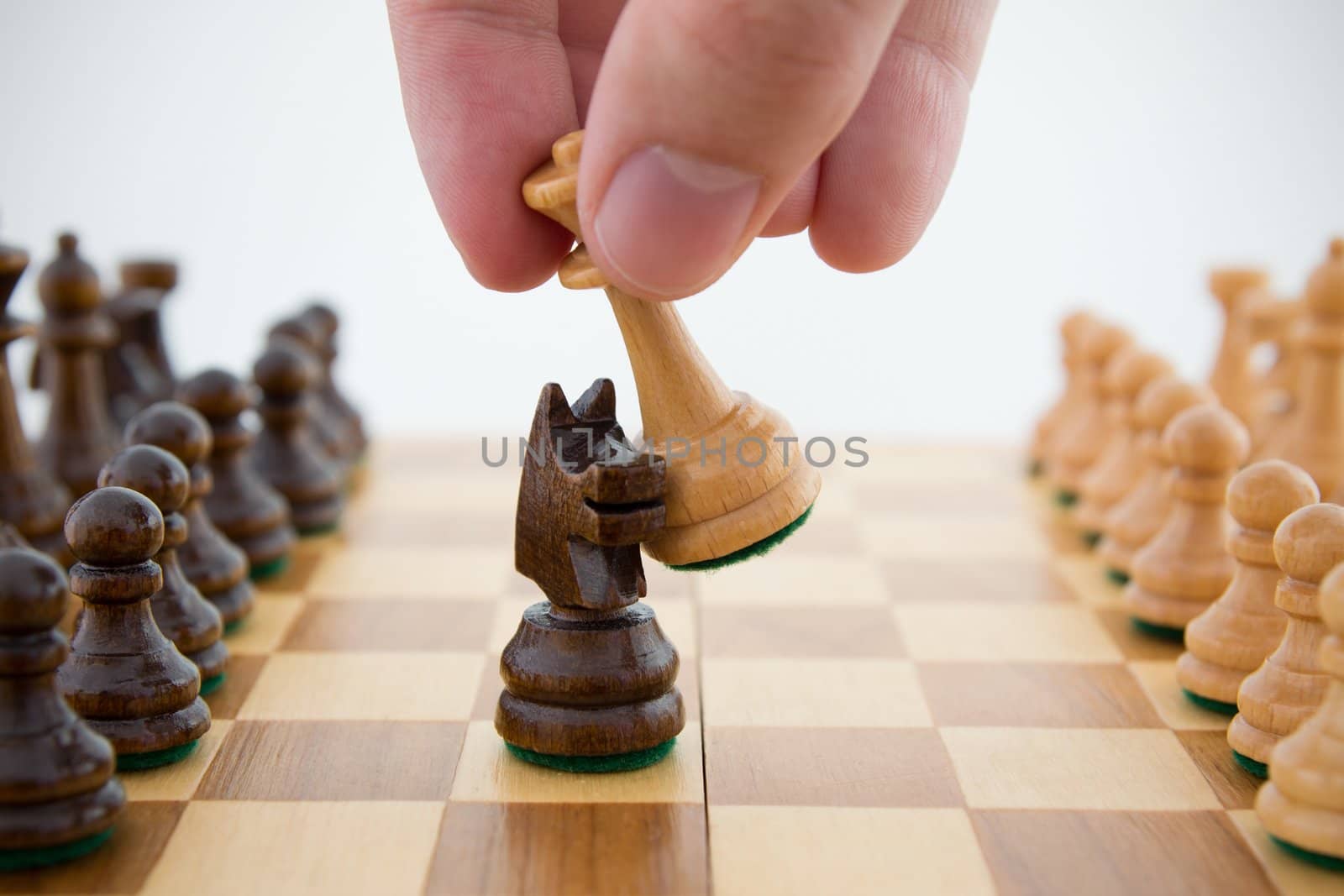 Chess game. Queen captures horse