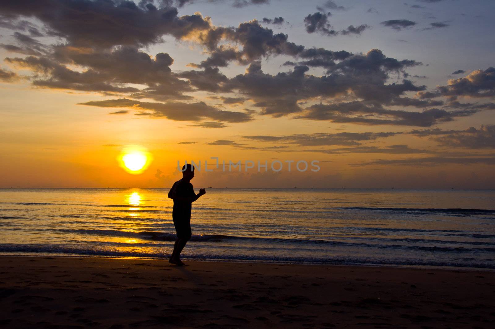 silhouette of man running on the beach