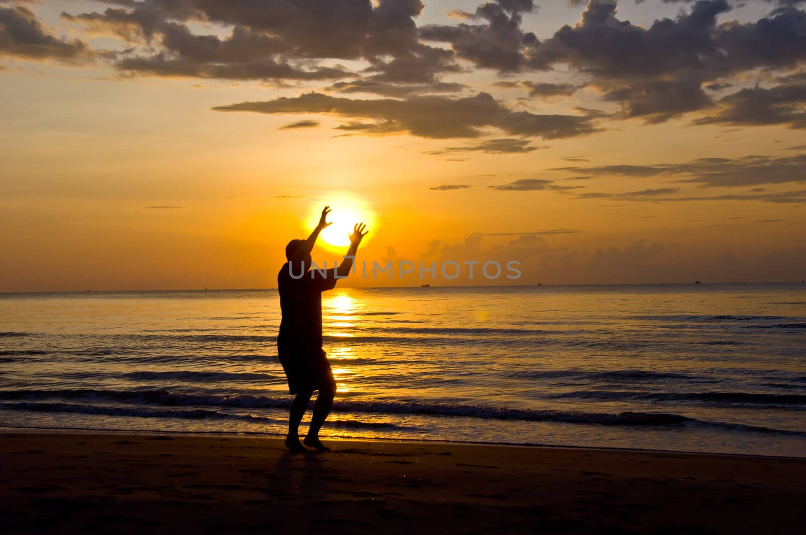 silhouette of man feel free and happy on the beach