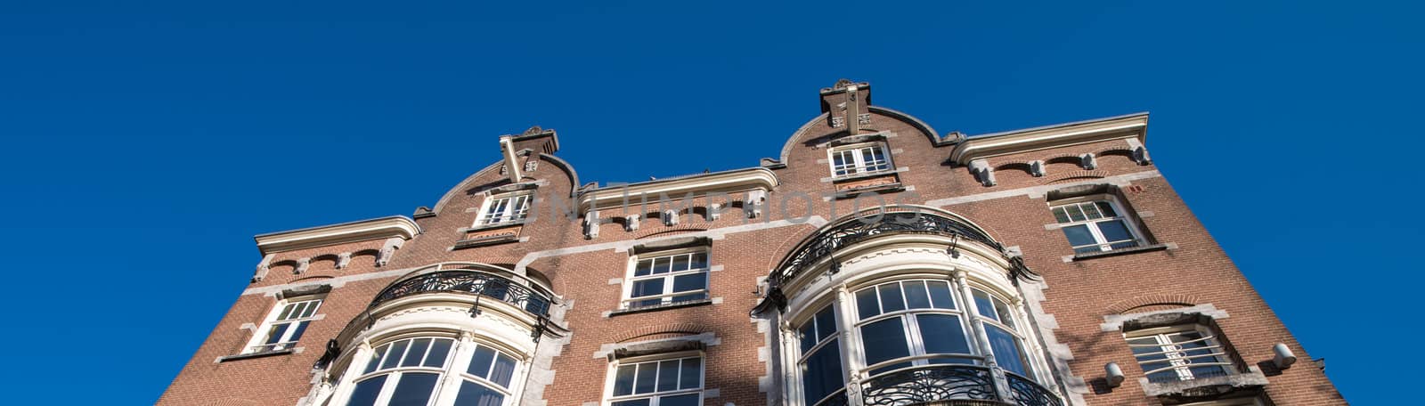 Amsterdam. Typical city buildings on a sunny day by jovannig