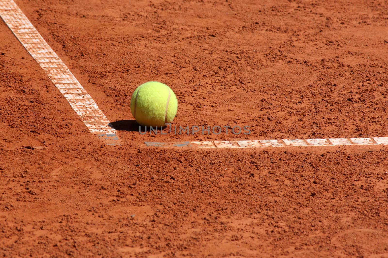 ball lying in corner of tennis court