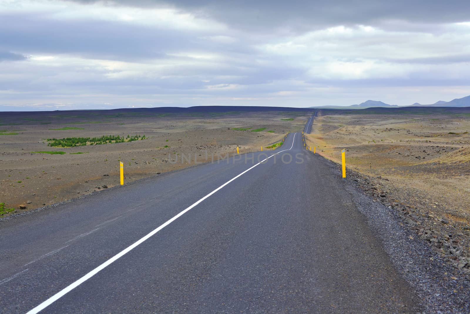 Highway through Iceland landscape at foggy day. Horizontal shot