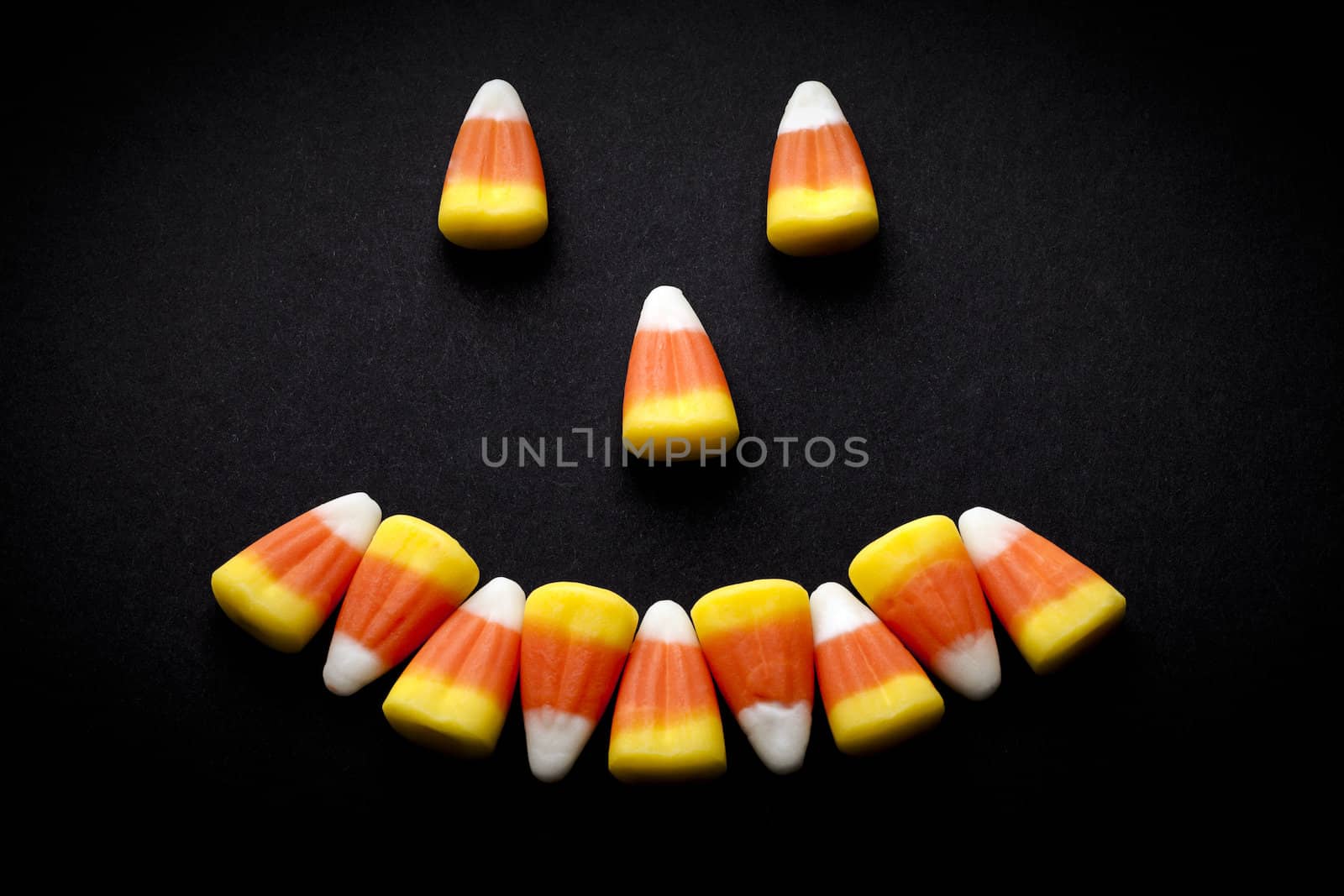 Candy corn forming a happy face.