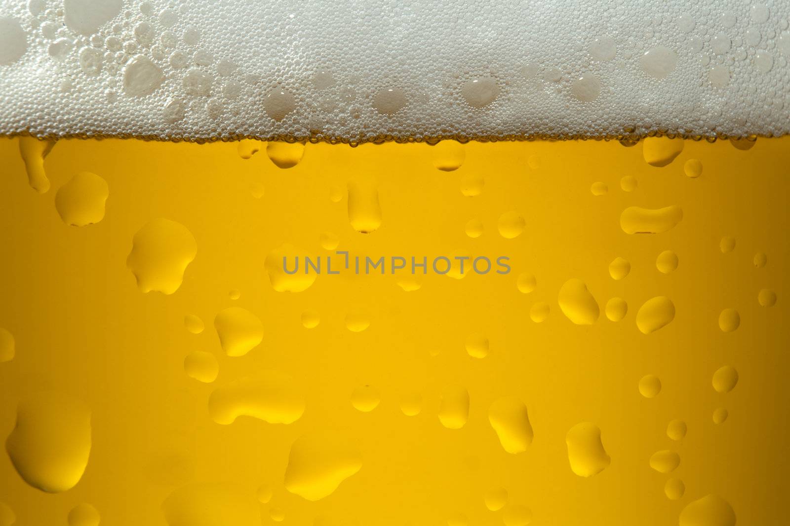 A close-up image of a yellow color beer into the glass 