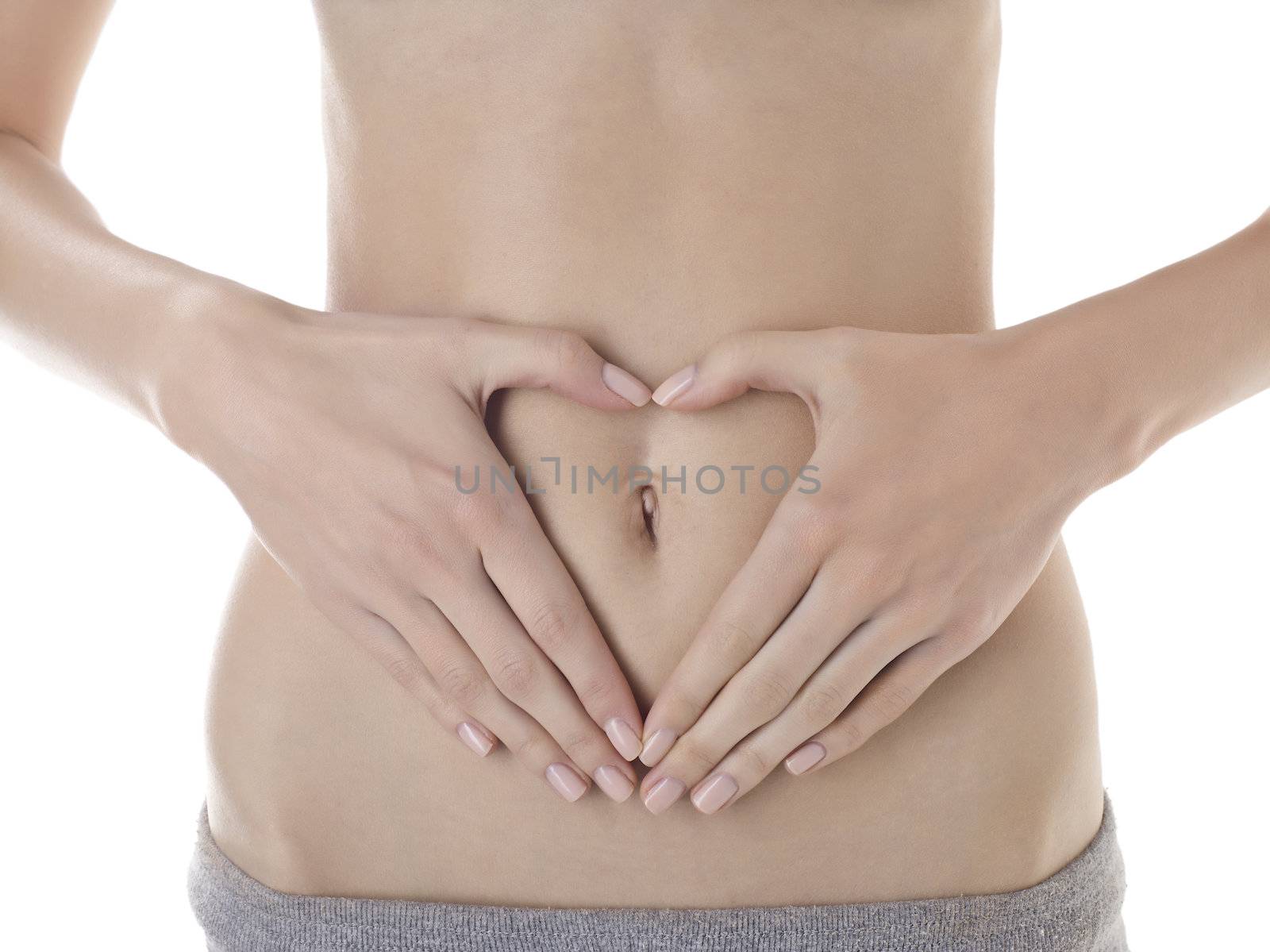Closed up shot of a woman's belly button with hands forming a heart shape