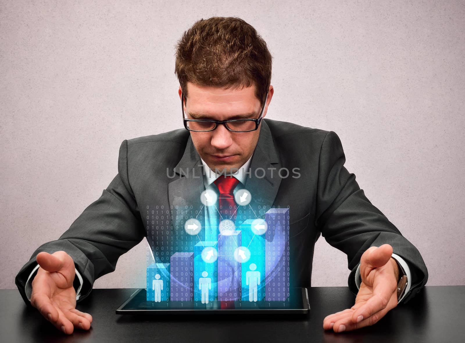 Businessman analyzing a chart on his tablet