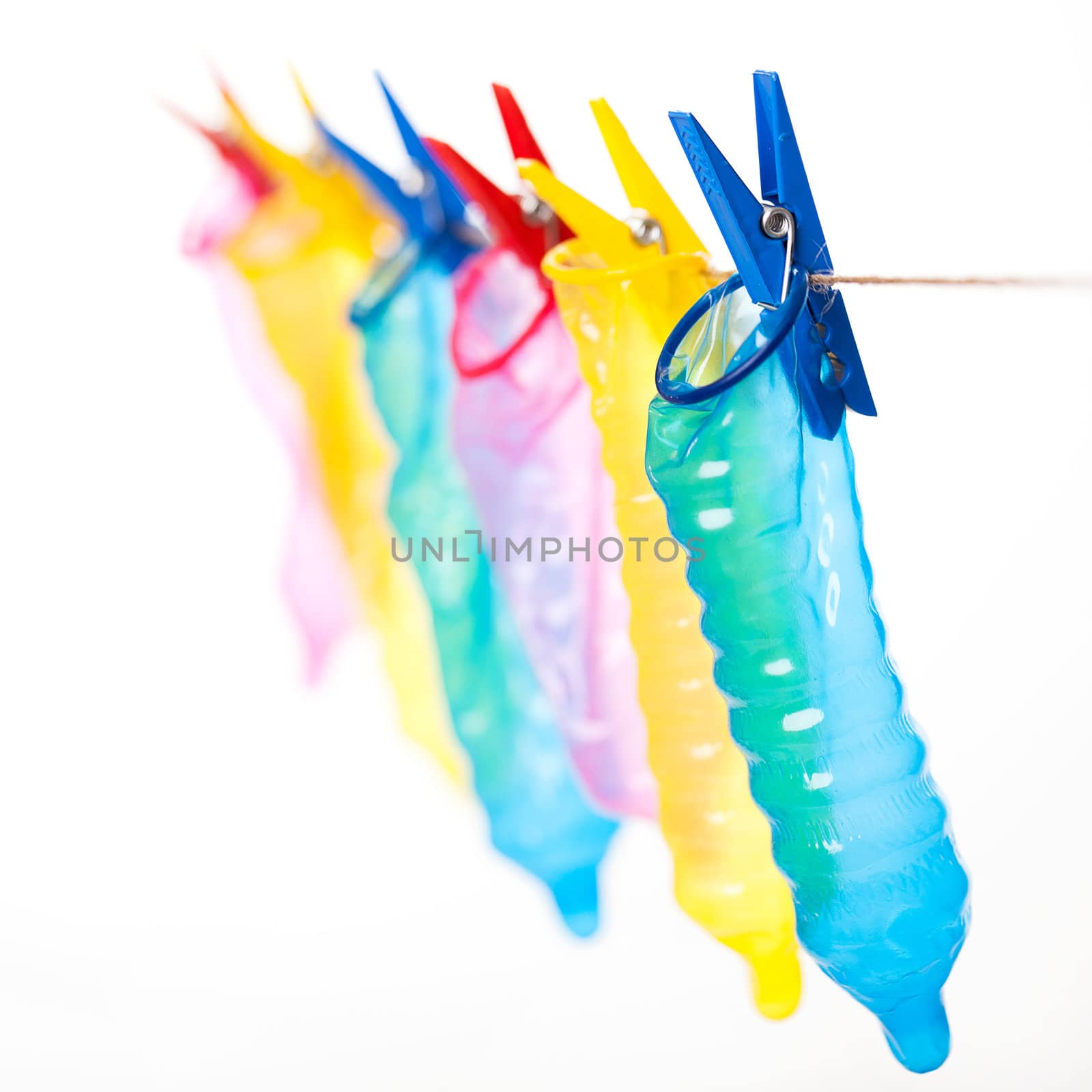 Colorful condoms with clothespins on a rope