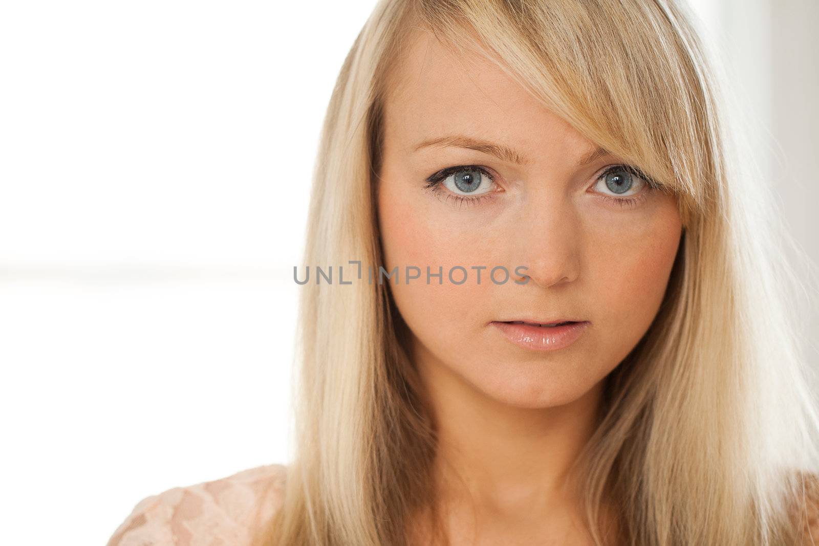 Young attractive woman posing over grey background