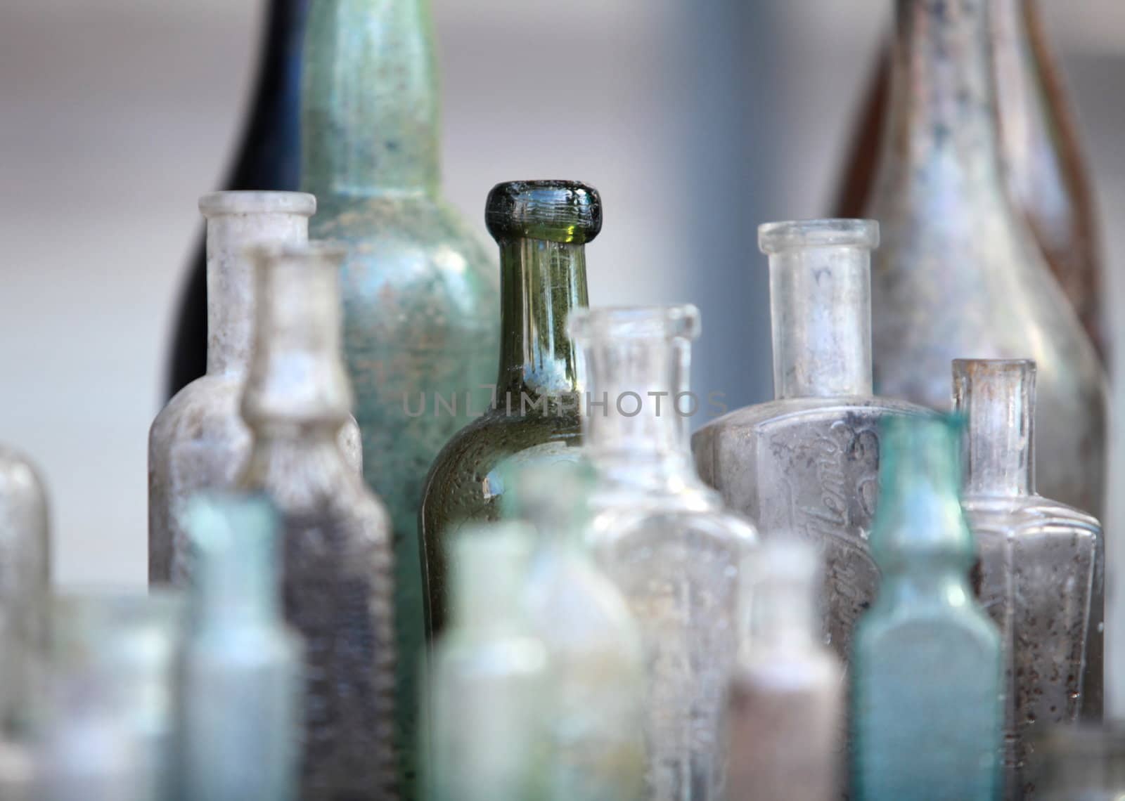 several old bottle on the table close to