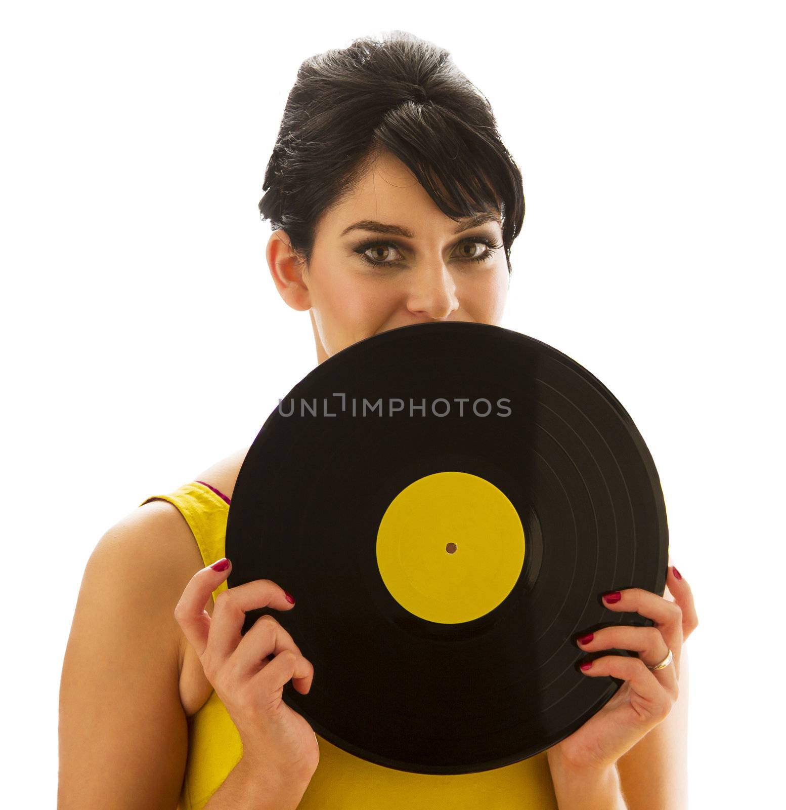 young woman in a yellow dress, looking over a record with a yellow label