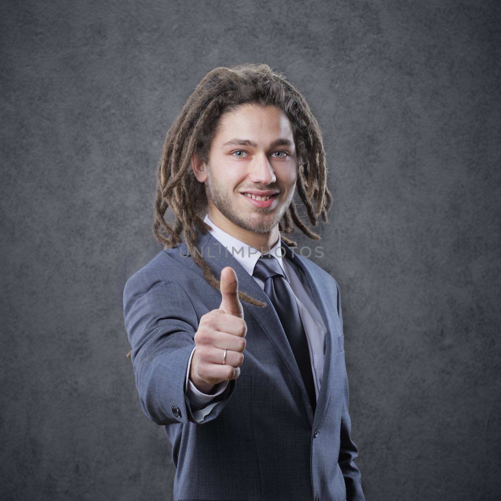 Happy businessman showing his thumb up