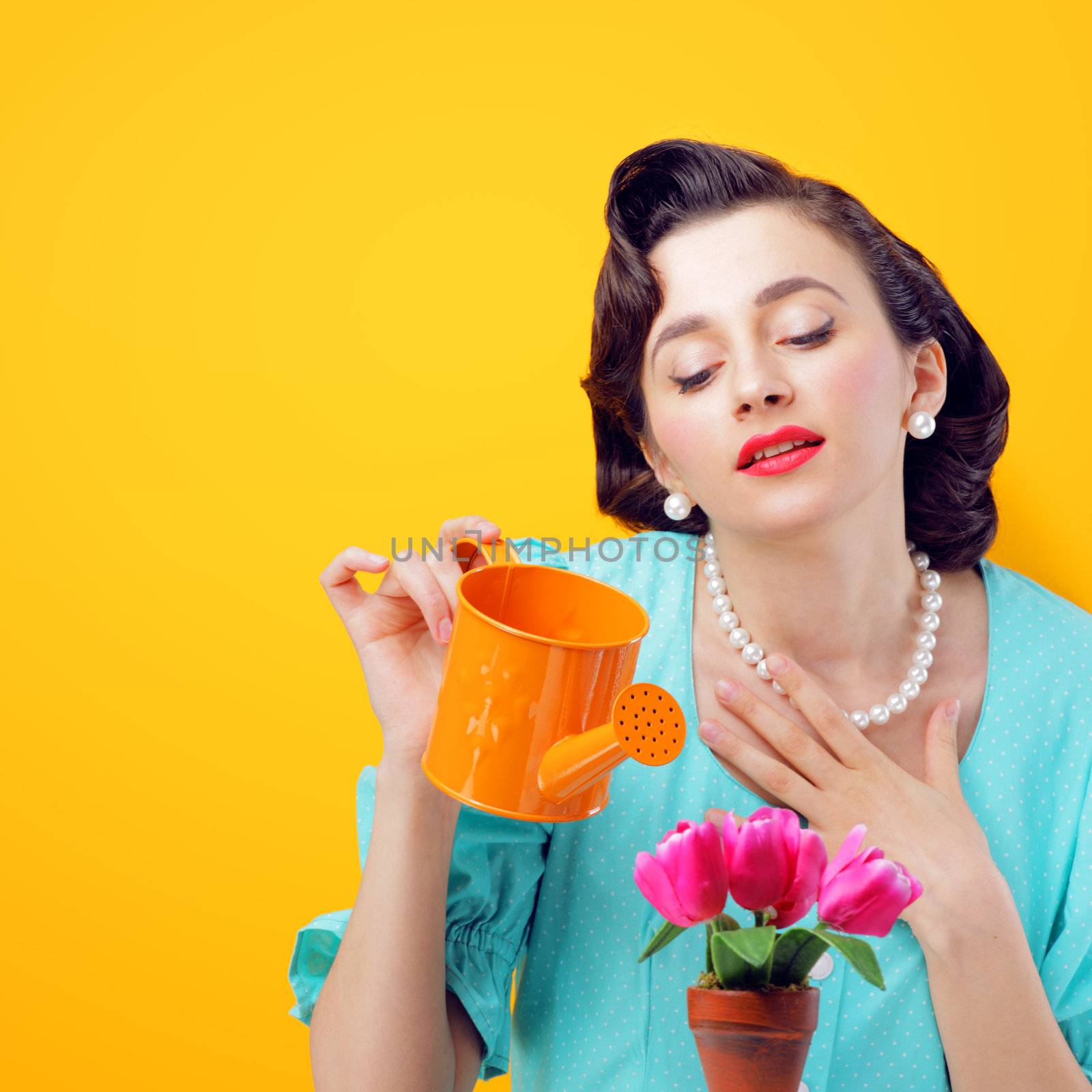 Pretty woman watering flowers, retro style