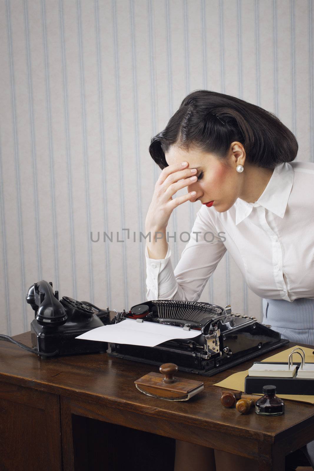 Woman having headache with hand on temple