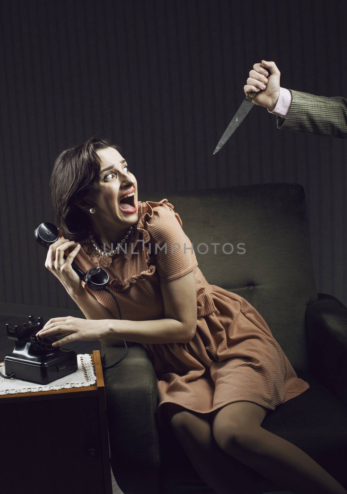 Terrified woman by a man murderess with a knife