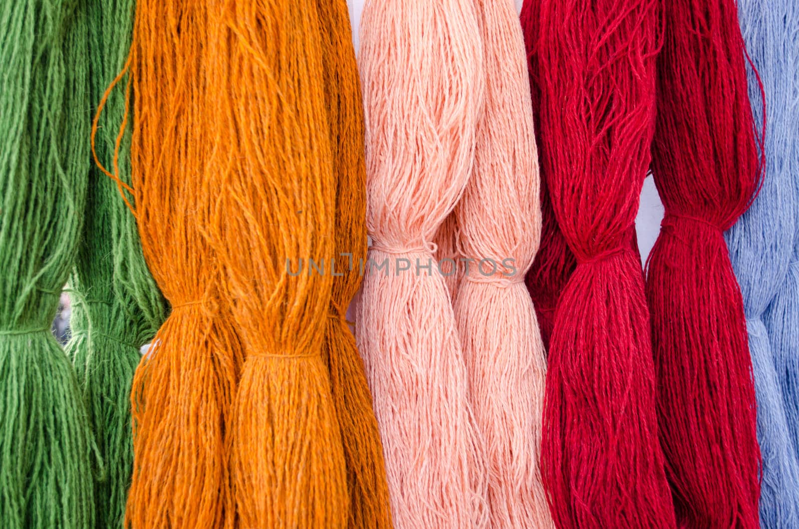 background of various colors wool threads closeup.