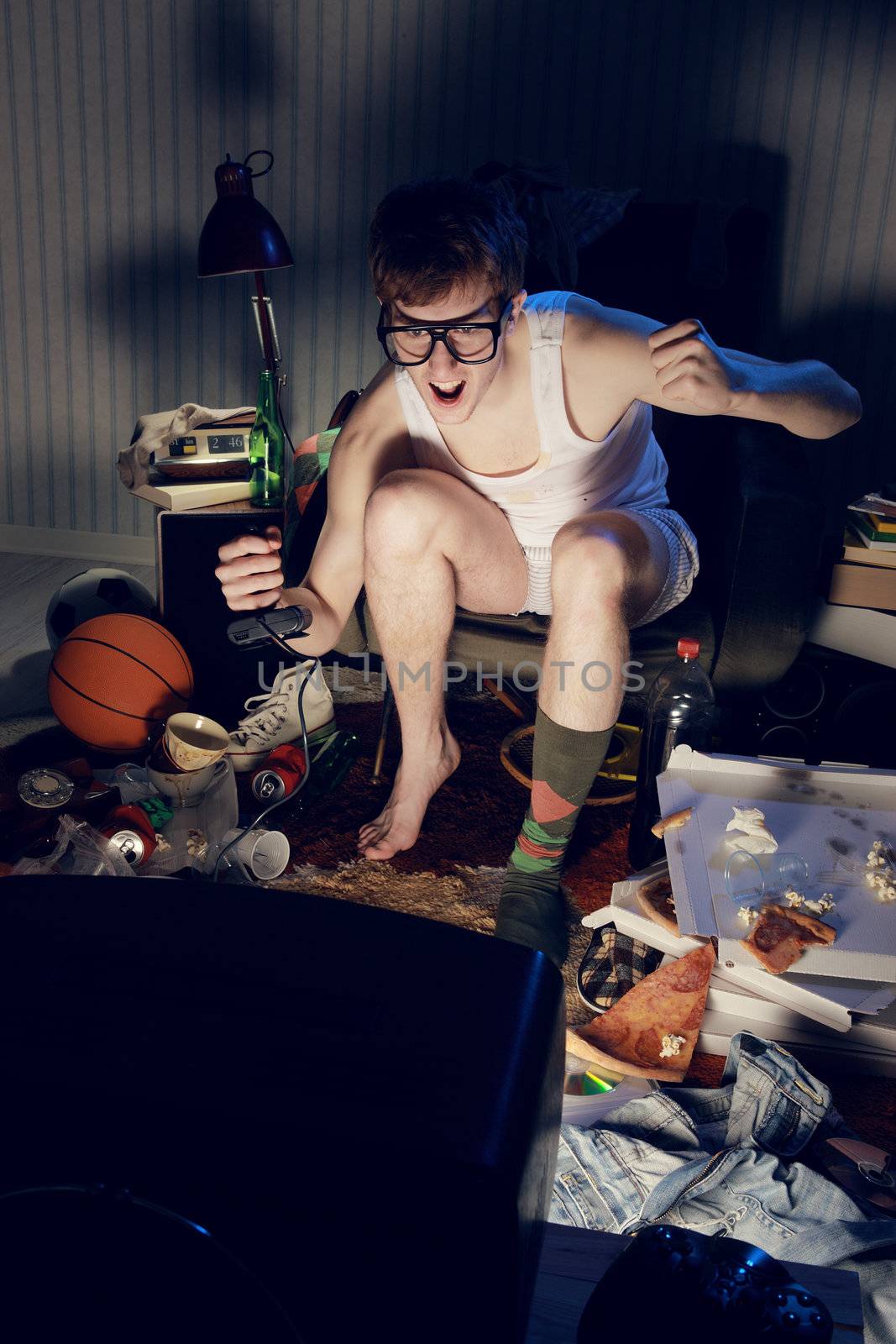 A excited teen plays video console games on His television