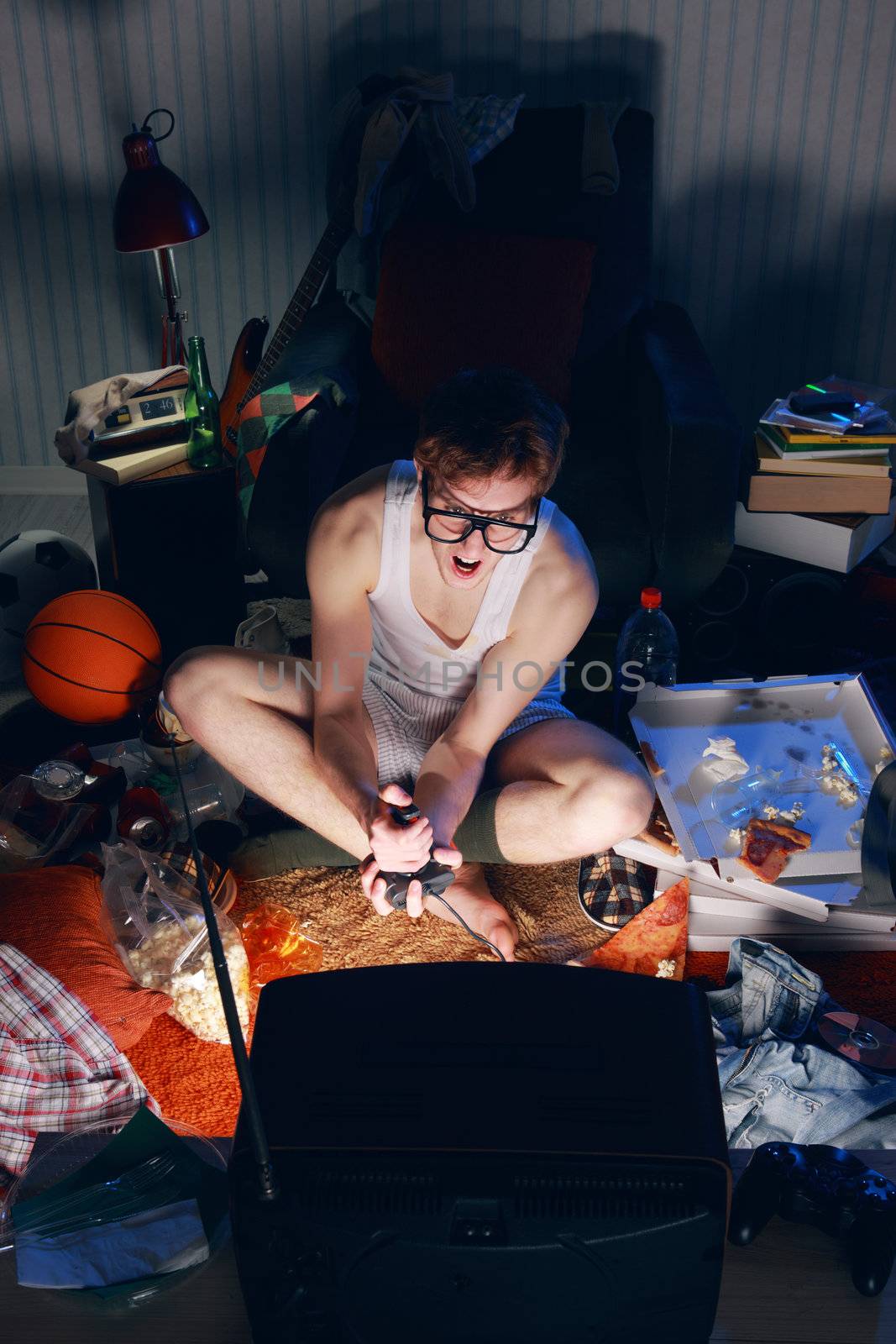 A excited teen plays video console games on His television