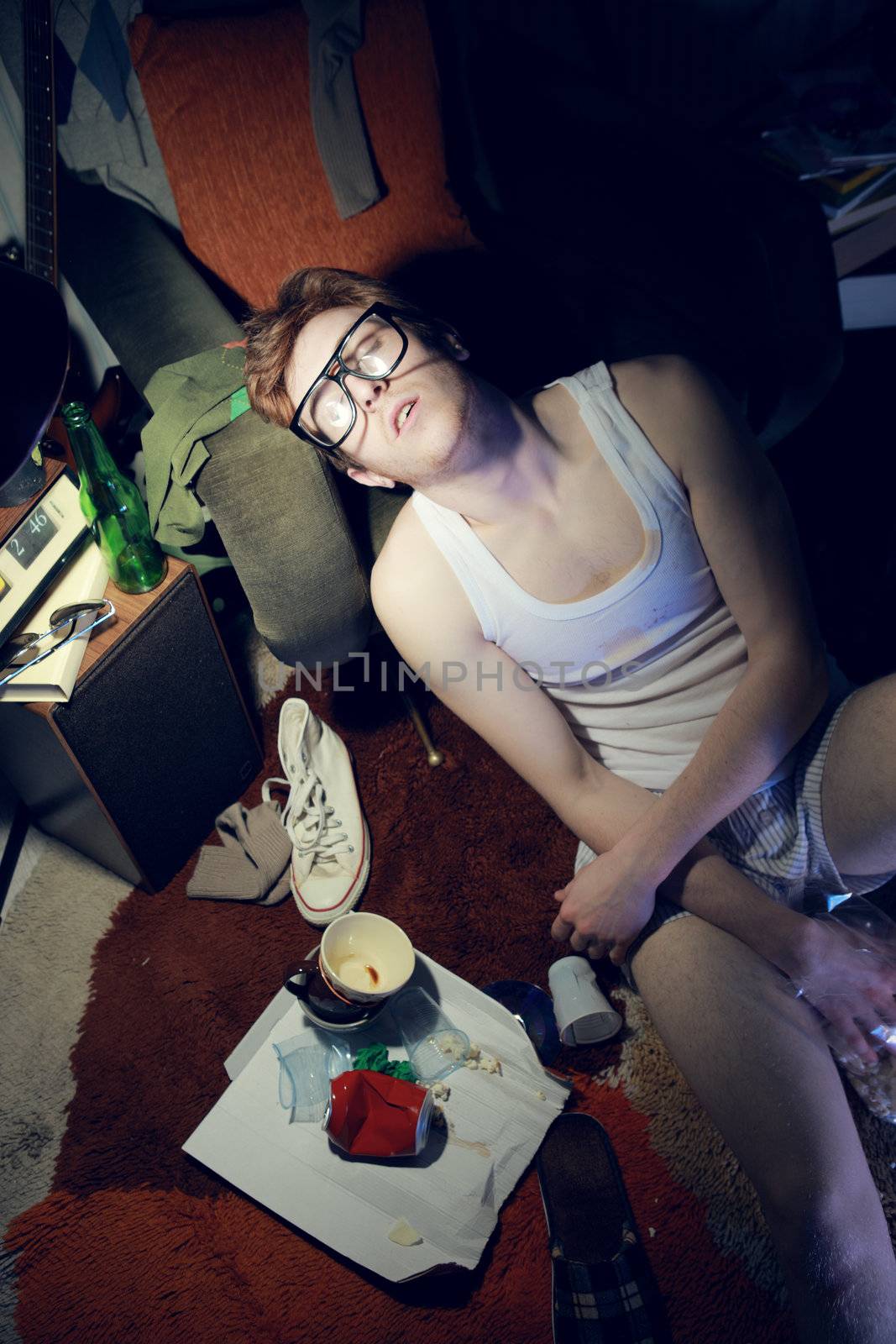 Guy in underwear lies slumped on the floor.