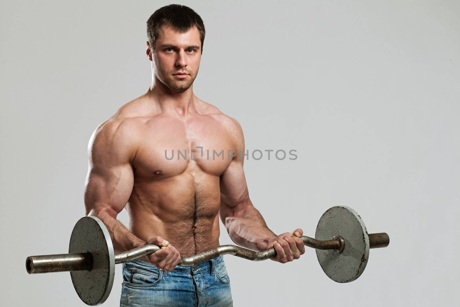 Handsome guy working out with dumbbells by rufatjumali