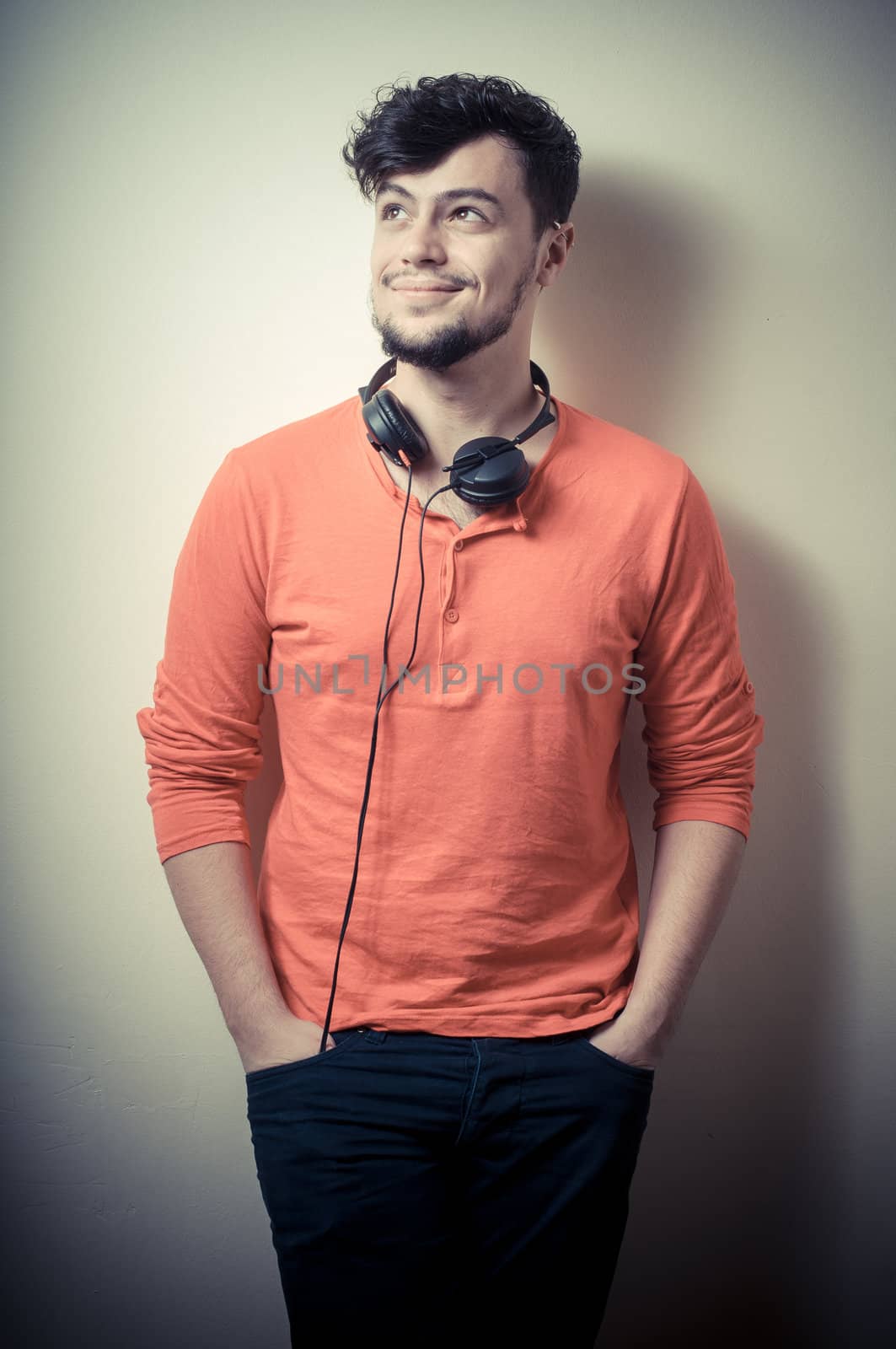 Stylish man listening to music on vignetting background