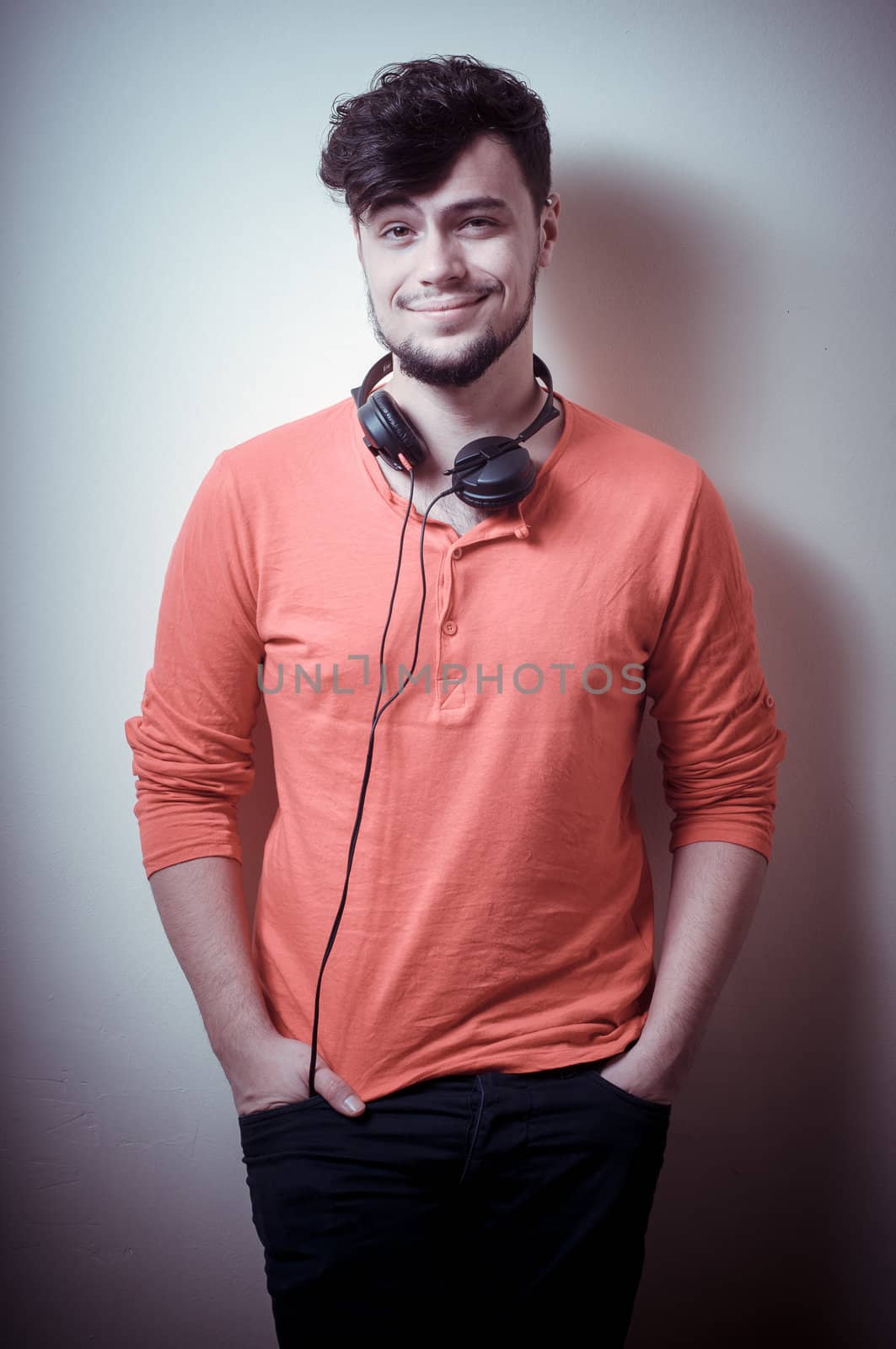 Stylish man listening to music on vignetting background