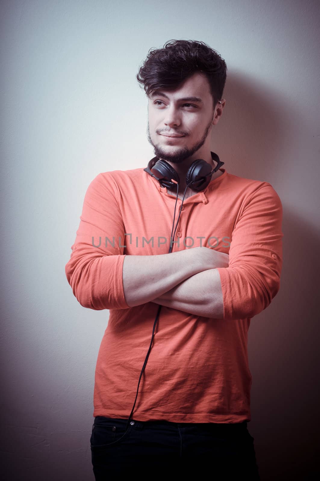 Stylish man listening to music on vignetting background