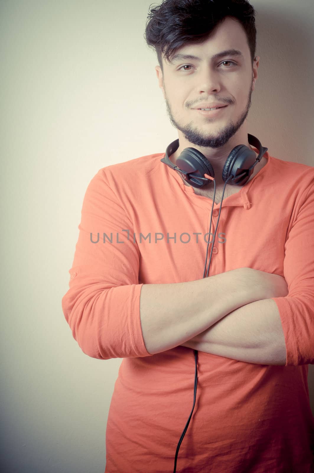 Stylish man listening to music on vignetting background