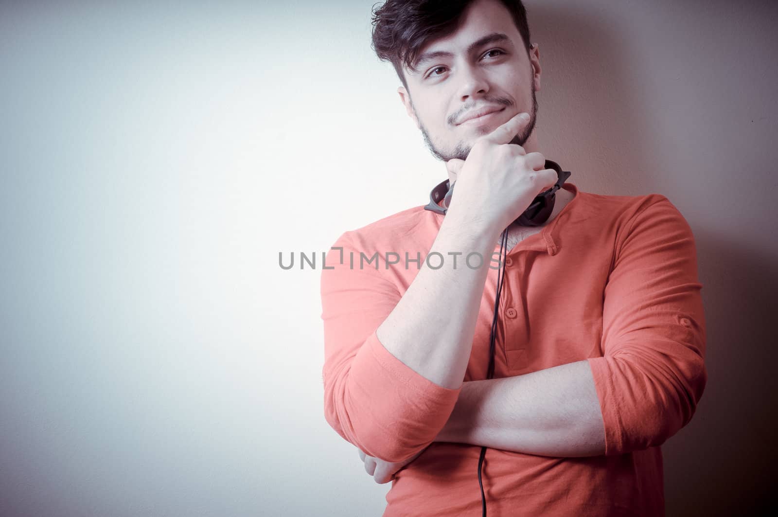 Stylish man listening to music on vignetting background