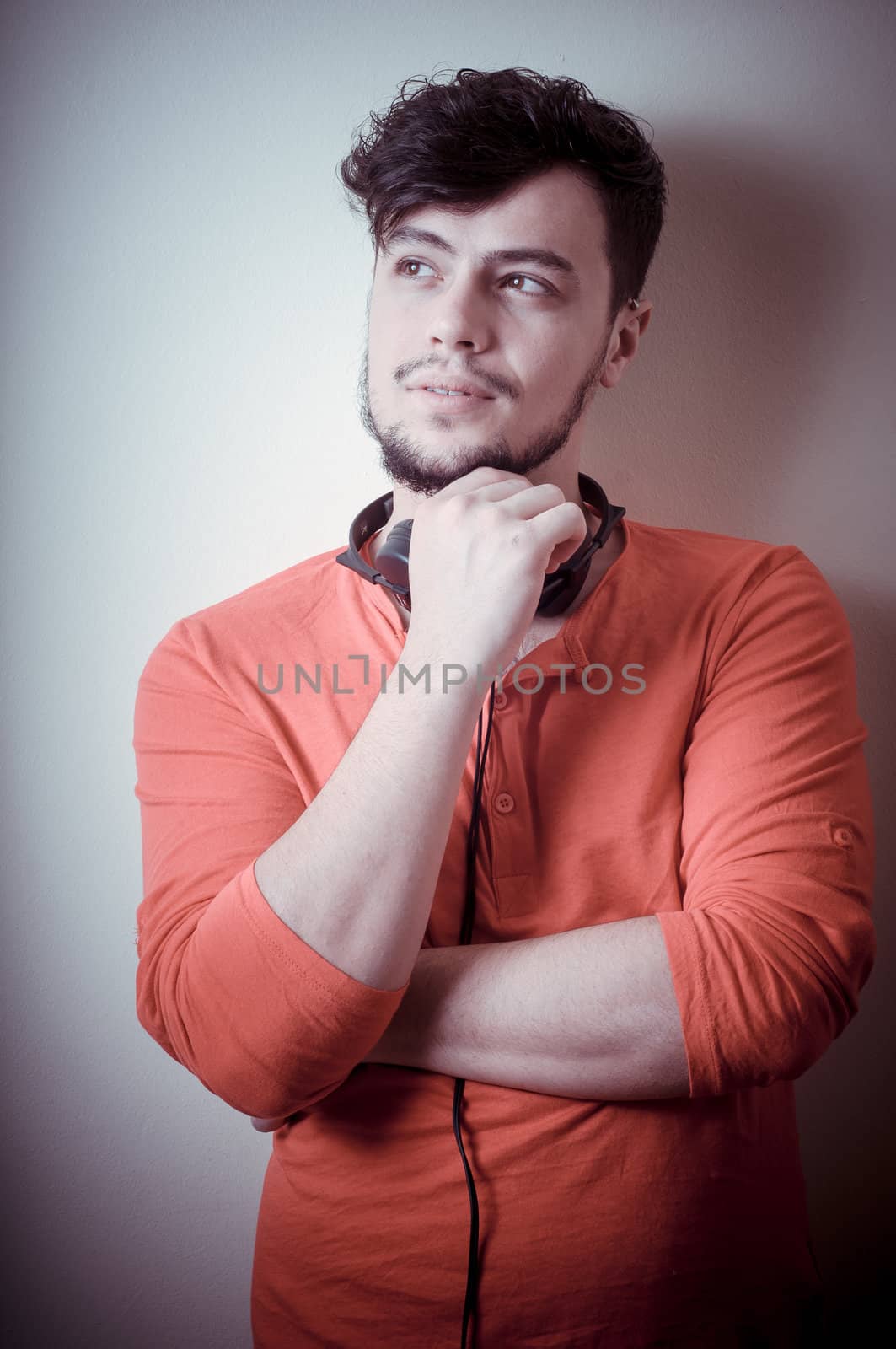 Stylish man listening to music on vignetting background